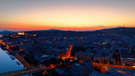 dusk time of the old town in bratislava, slovakia. well-lit bratislava castle on the hill. aerial view