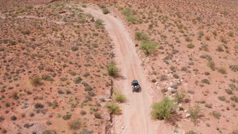 overhead aerial following a dune buggy in the desert