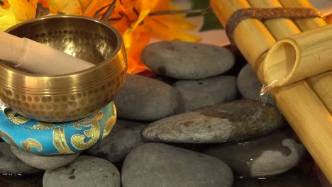 Tibetan-bell-with-rocks-leaves-and-water-fountain