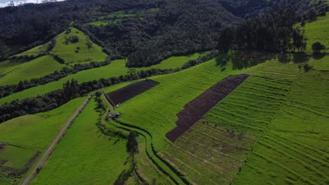 Aerial-Drone-Flying-Over-Green-Mountain-Foothill-Farms-of-the-Pasochoa-volcano,-Puichig,-Cantón-Mejía,-Pichincha-Province,-Ecuador