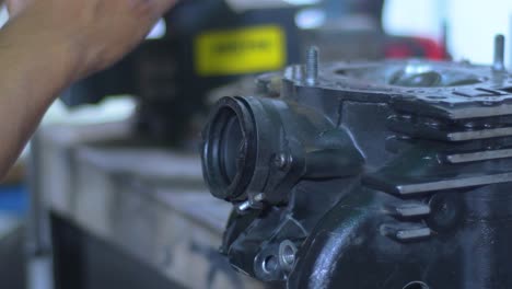 engine block under maintenance, mechanic's hands background