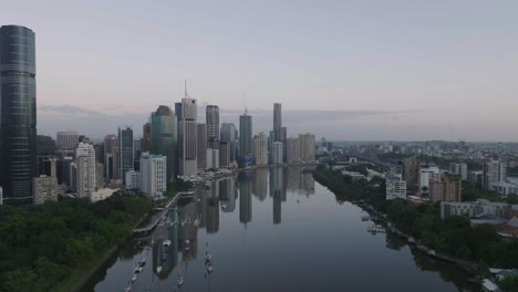 cinematic drone towards brisbane city at sunrise