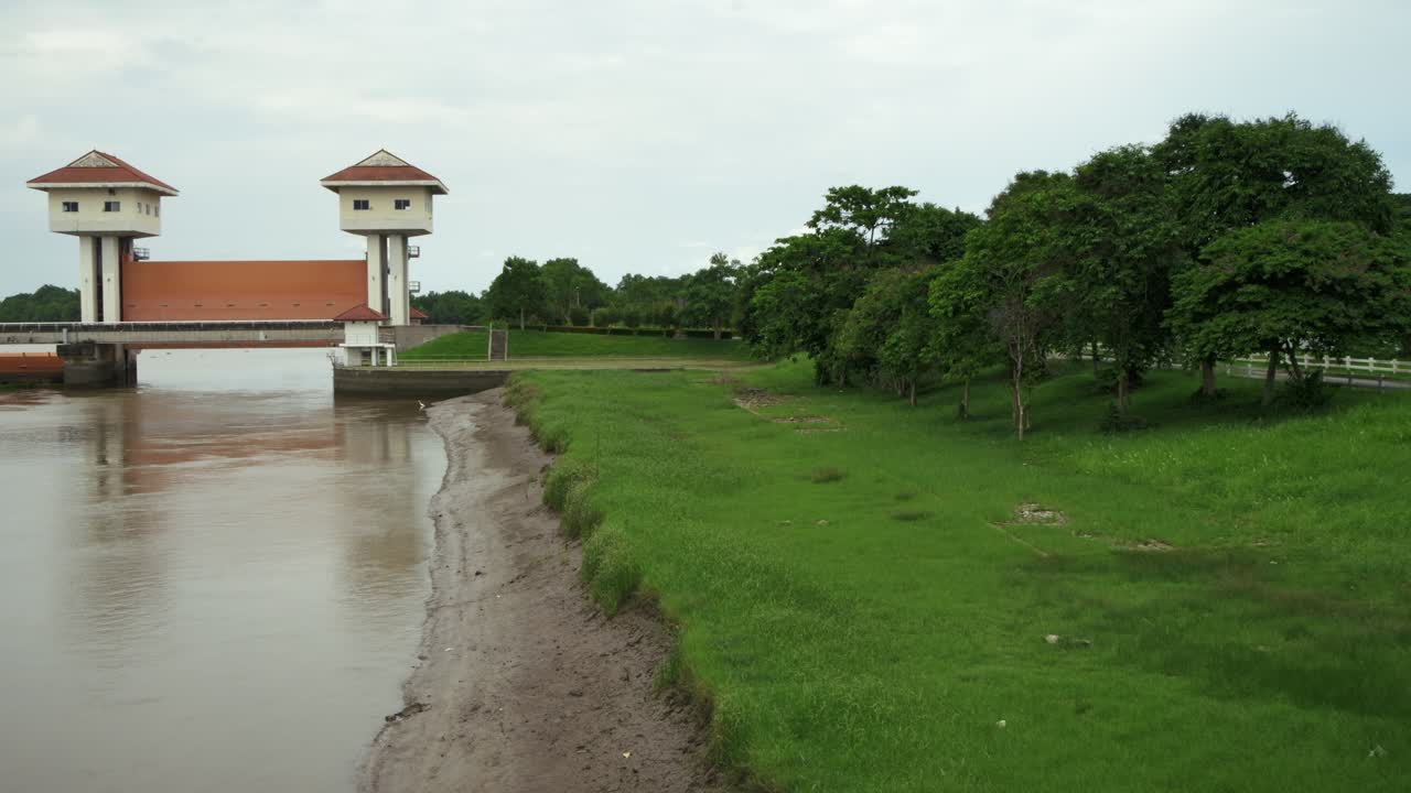 A tranquil view showcasing a waterway infrastructure alongside lush greenery a serene rural setting