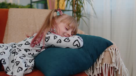 little tired lazy sleeping children girl lying asleep on sofa feeling lack of energy at home alone