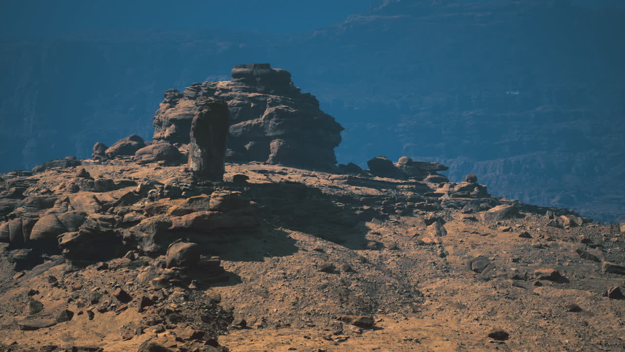 Majestic rock formations under blue sky at mountainous desert landscape