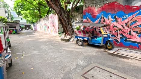 colorful tuk-tuk in a graffiti alley