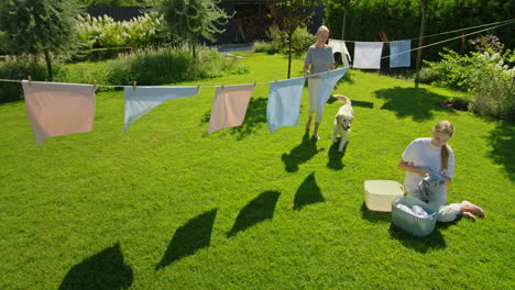 mother and daughter doing laundry outside