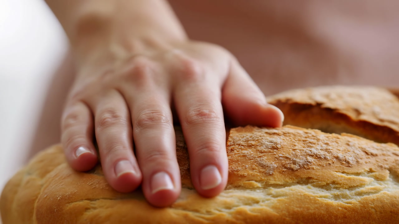 Closeup Caucasian Hand Pressing Crusty Bread Loaf, Warm Golden Crust Under Gentle Palm, Home Baker Checking