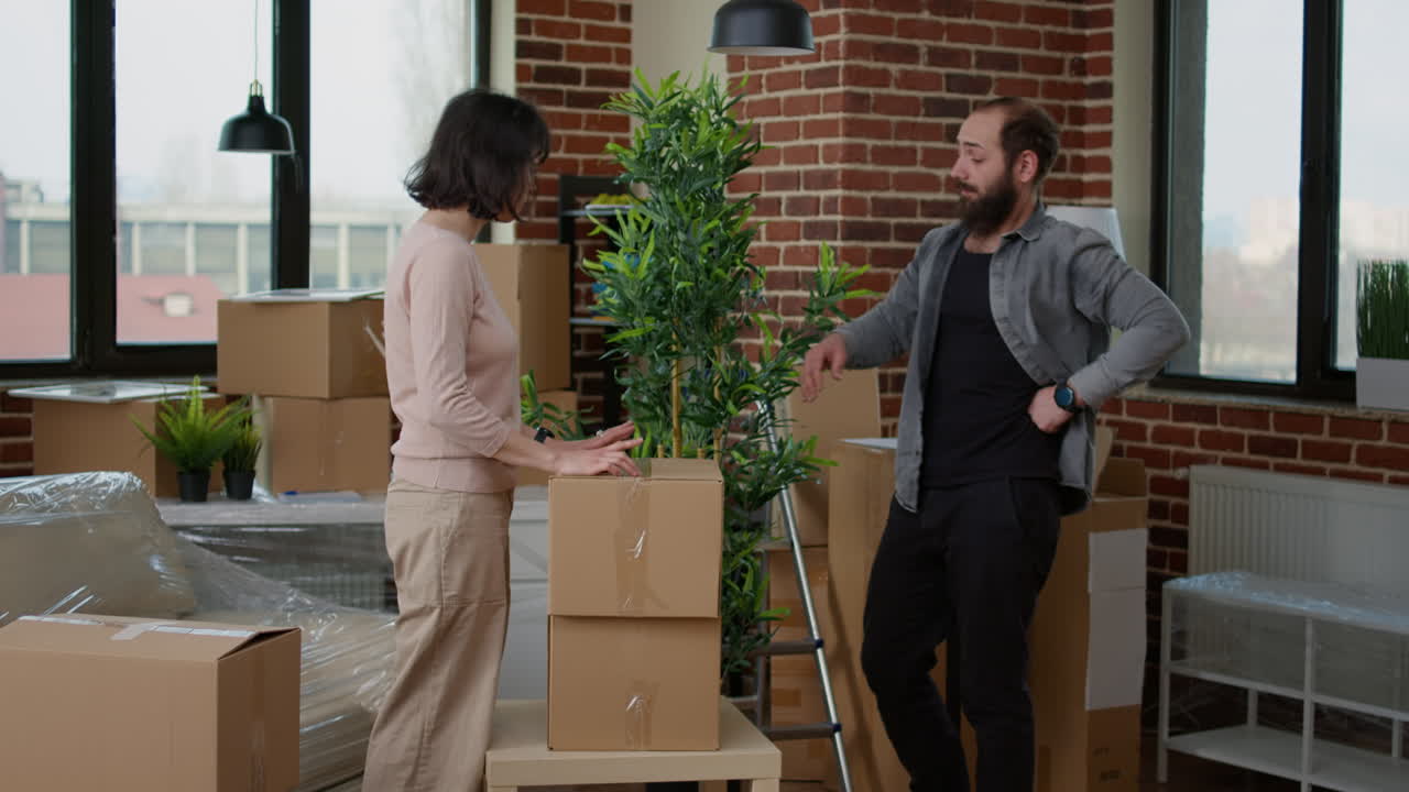 Young married couple carrying furniture to decorate new apartment