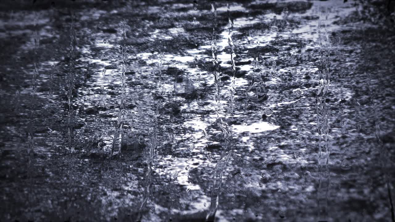 Heavy rain shower downpour cloudburst rainfall behind the glass.