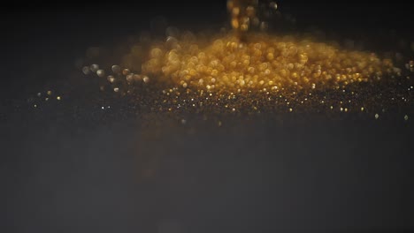 Gold-dust-falls-on-a-black-background