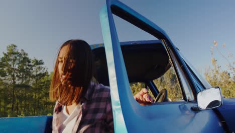 Young-woman-on-a-road-trip-in-pick-up-truck