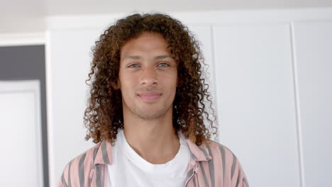 young biracial man smiles confidently at home