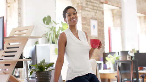 young african american businesswoman enjoys a coffee break at the office
