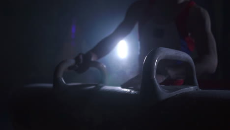 Close---up-of-Pommel-horse-on-a-dark-background-and-smoke-in-slow-motion-male-hands-magnesia.-Preparation-for-the-performance.-Olympic-games