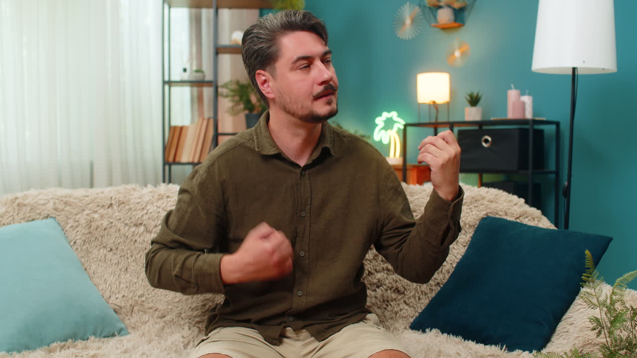 Middleaged man air guitar playing enthusiastic moves pretend rock music energetic fun joyful vibe