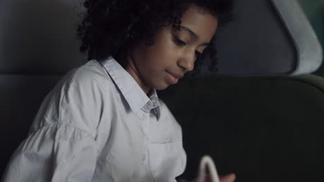 African-american-girl-drawing-album-at-break-holding-funny-pencil-close-up.