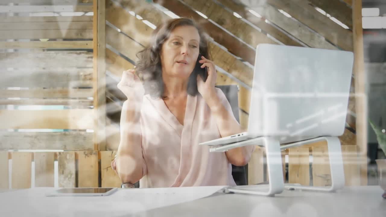 Animation of digital icons over businesswoman using smartphone