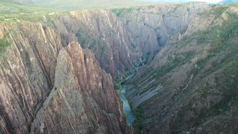 aerial drone footage reveal shot of the black canyon of the gunnison national park in montrose colorado with the river flowing at the bottom of the rocky mountains