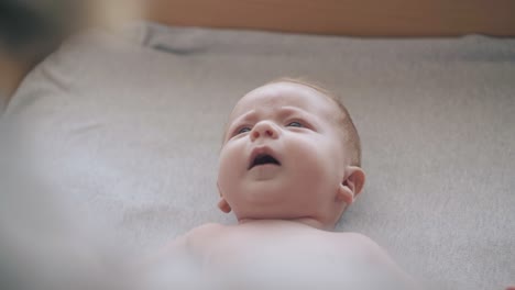 skilled pediatrician crosses and opens newborn baby arms