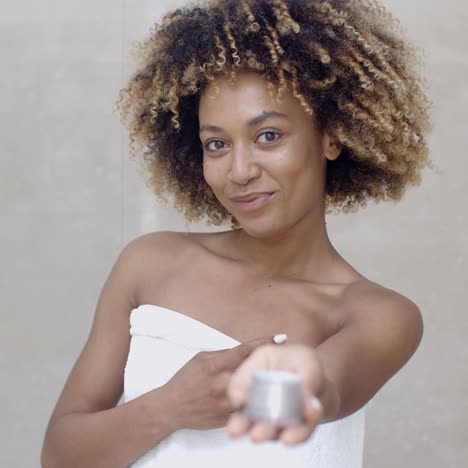 cosmetic cream container in woman hand