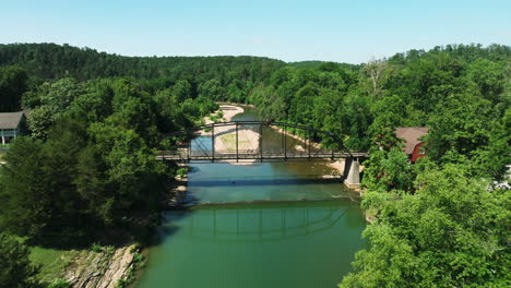 flying towards the historical bridge of war eagle in arkansas,united states - drone shot