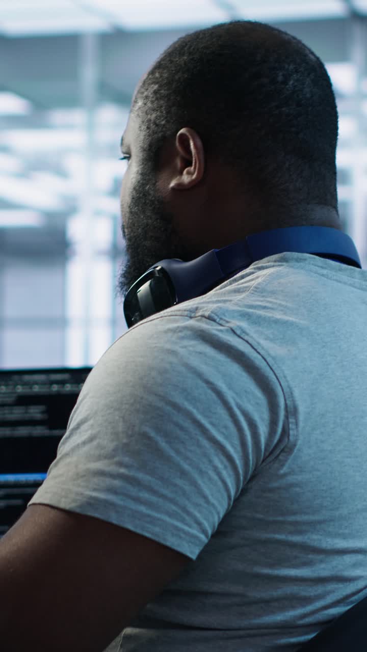 African American Programmer Working on Computer and Smiling