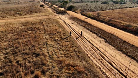 Farm-Security-Employees-check-inside-fence-at-high-risk-boundary-where-properties-meet,-ensuring-safety-in-this-rural-secluded-area