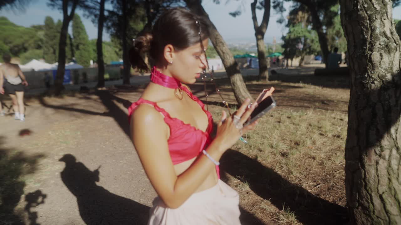 Woman using her phone at an outdoor festival or park