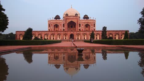 humayun's tomb at golden hour with pond reflection