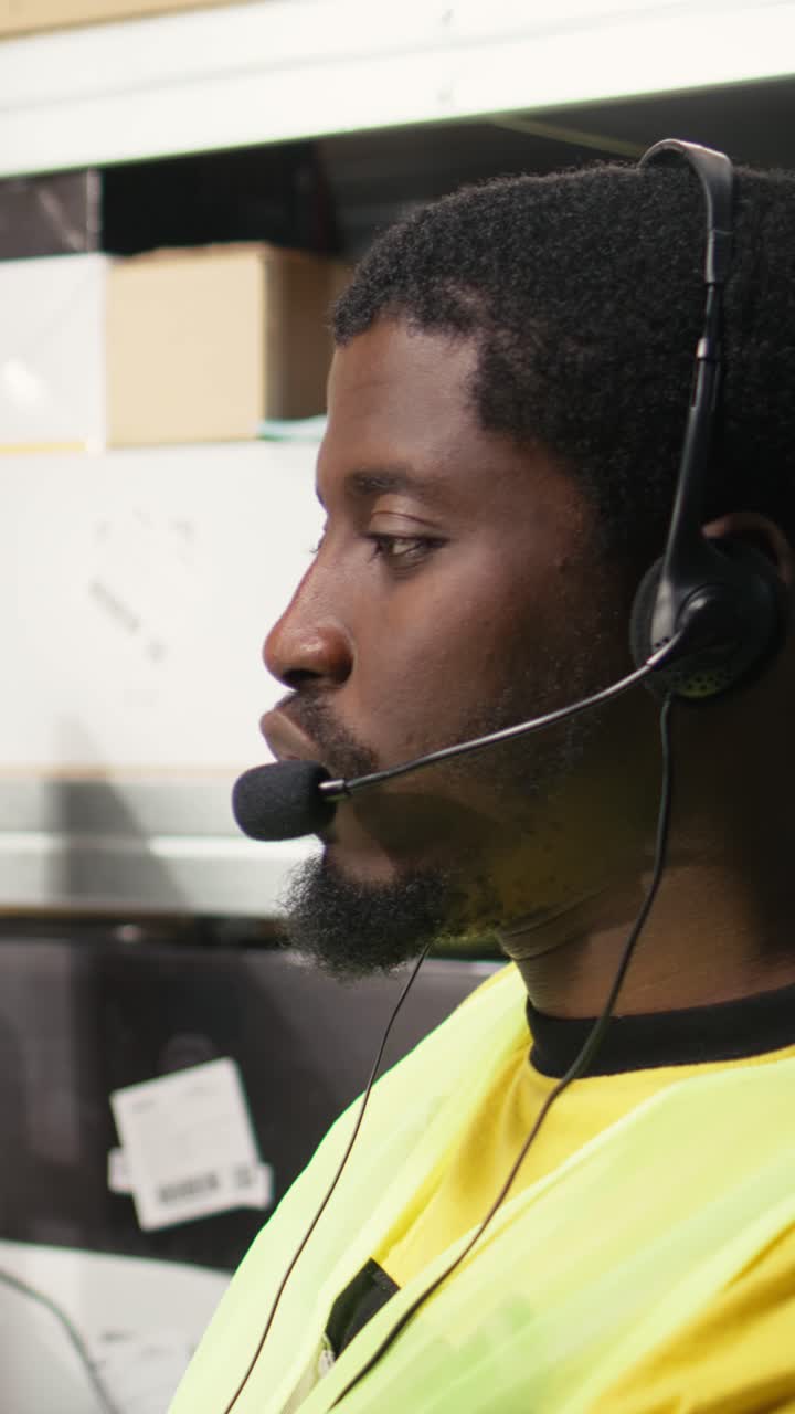 Vertical Video African american operator helping clients with delivery issues
