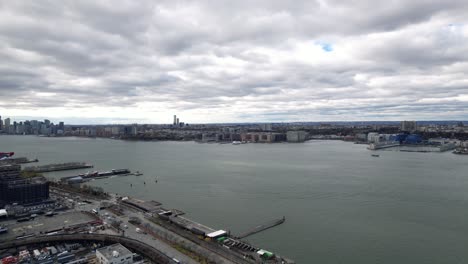 hudson river, facing jersey city and hoboken from manhattan, aerial on cloudy winter day