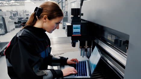 woman engineer working on industrial machinery
