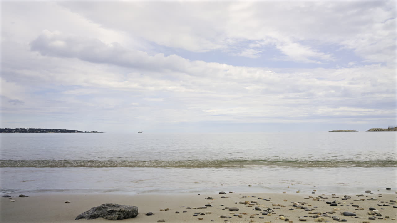 Time lapse of waves hitting the shore in Cannes, France on a cloudy day