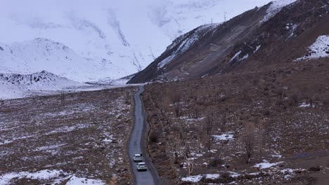 snowy mountain road with cars