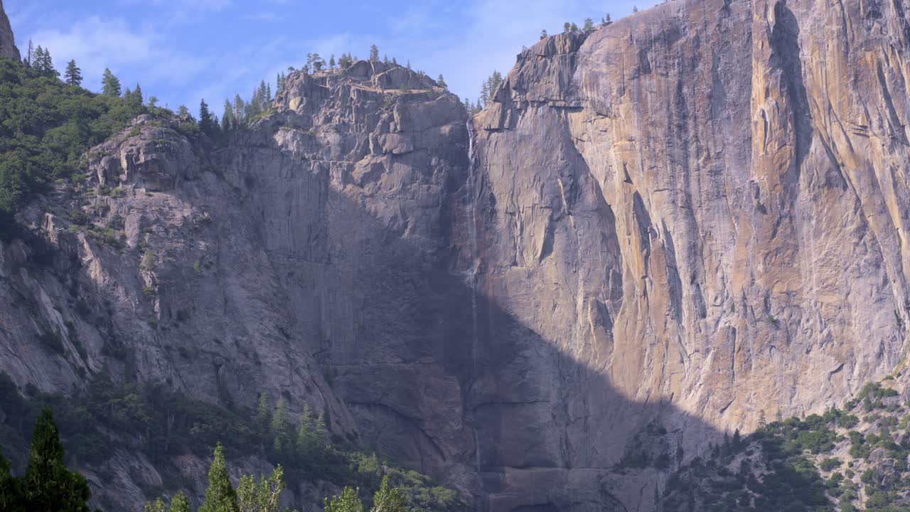 Minimal Snowmelt at Upper Yosemite Falls – Closeup Waterfall Shot. The footage shows reduced water flow due to low snowmelt for the season, highlighting the dry conditions in Yosemite National Park