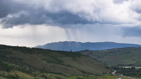 Nubes-De-Tormenta-En-El-Horizonte-De-Un-Paisaje-Montañoso-En-Silverthorne,-Colorado,-Lluvia-Torrencial-En-La-Distancia-Con-álamos-A-La-Vista,-Camiones-Aéreos