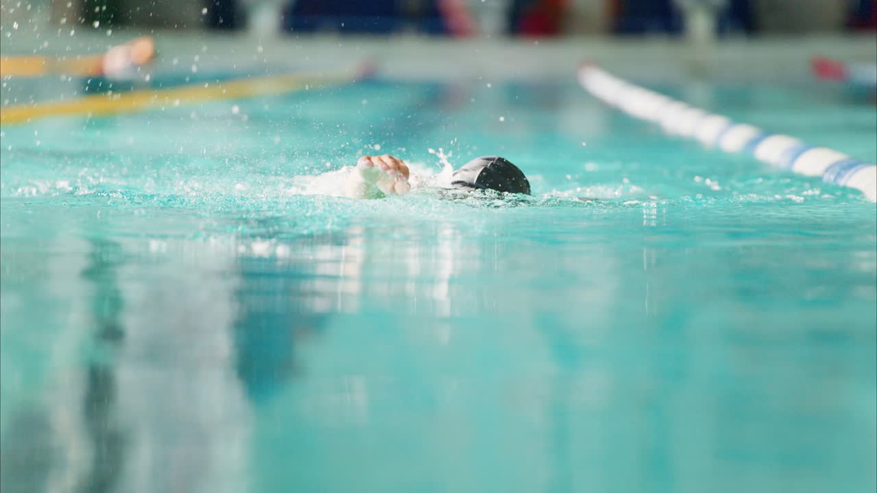 A Swimmer's Journey Through Water: Capturing the Essence of Competitive Swimming in Two Dynamic Frames from an Intense Pool Training Session
