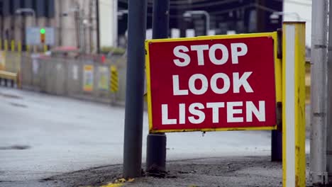 "stop look listen" pedestrian street sign in braddock, pennsylvania