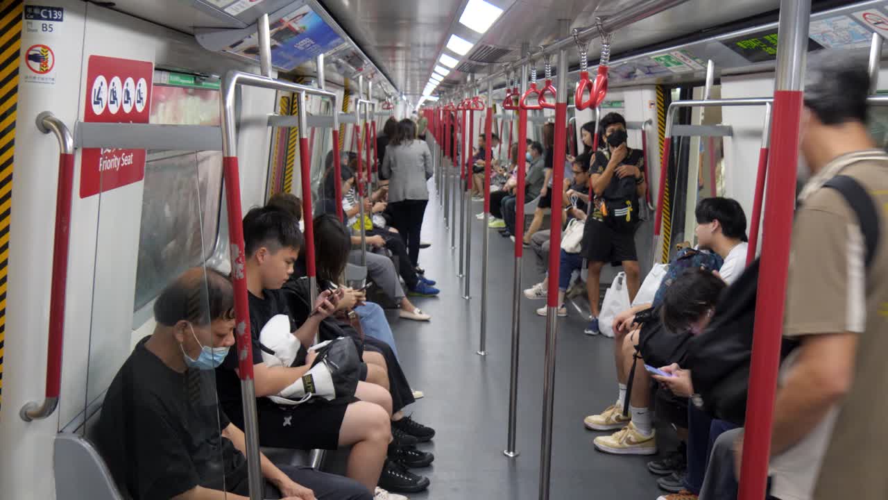 Passengers inside a busy subway train