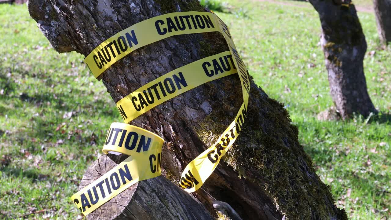 Warning for caution written on yellow ribbon