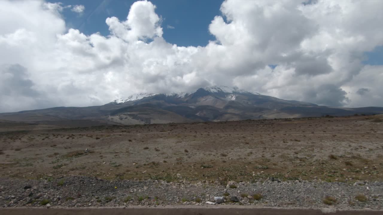 Driving by Chimborazo mountain volcano Ecuador nature landscape sky full of clouds