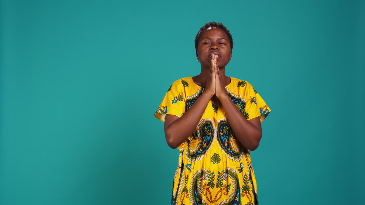 Spiritual hopeful woman holding hands in a prayer and having belief in Jesus
