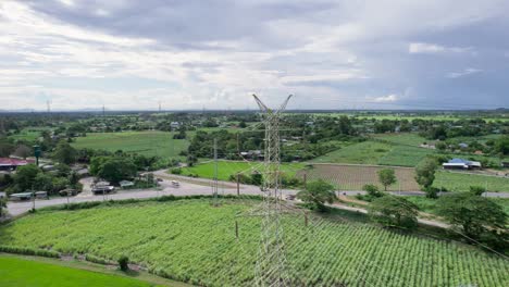 high voltage pole, transmission tower, electricity pylon, electric power transmission located on rice field in the countryside