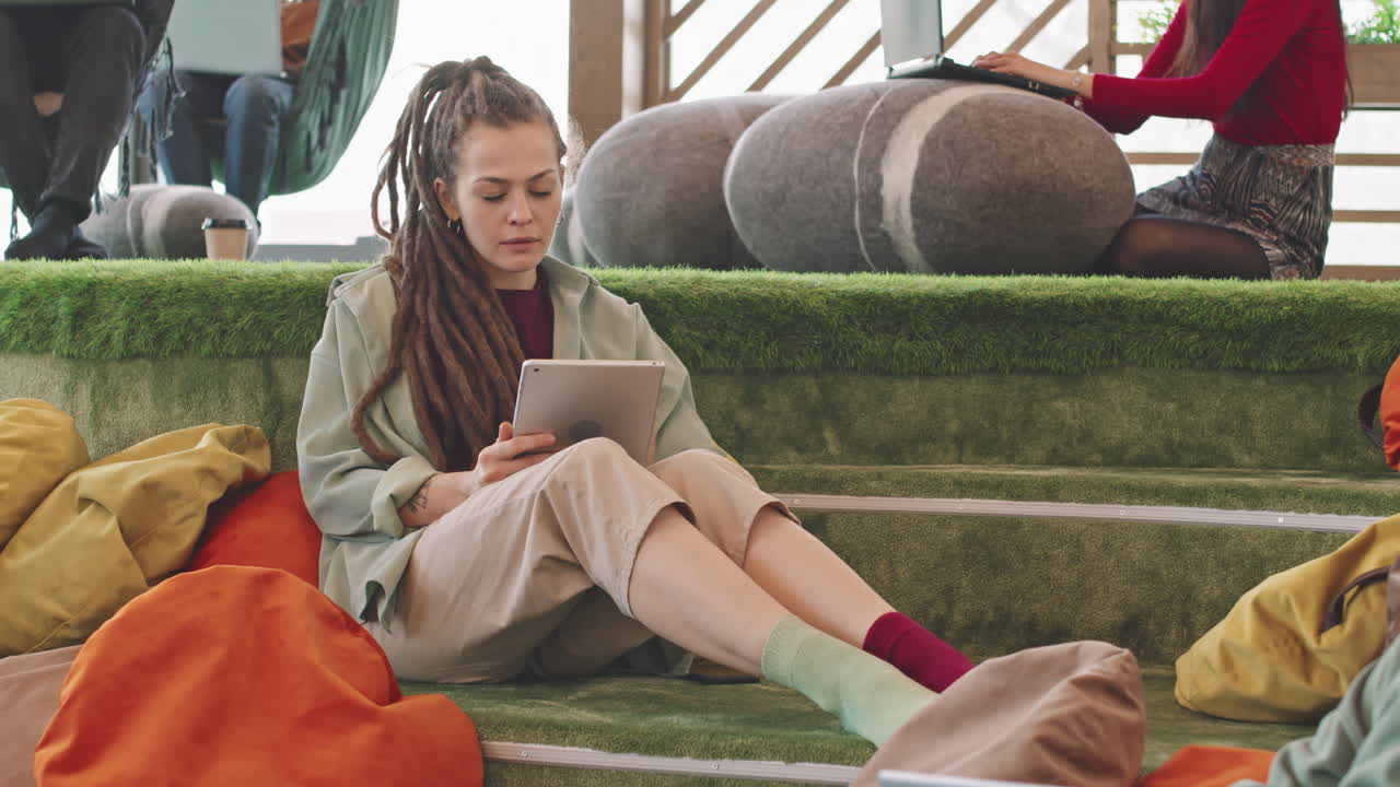 Woman Working on Tablet in Modern Coworking Space