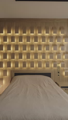 modern bedroom with illuminated wooden headboard