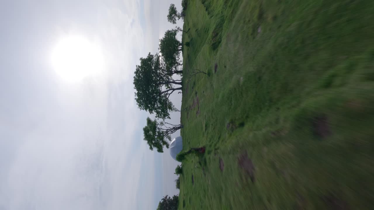 Premium stock video - Vertical fast fpv drone shot over bukit asah camp ...
