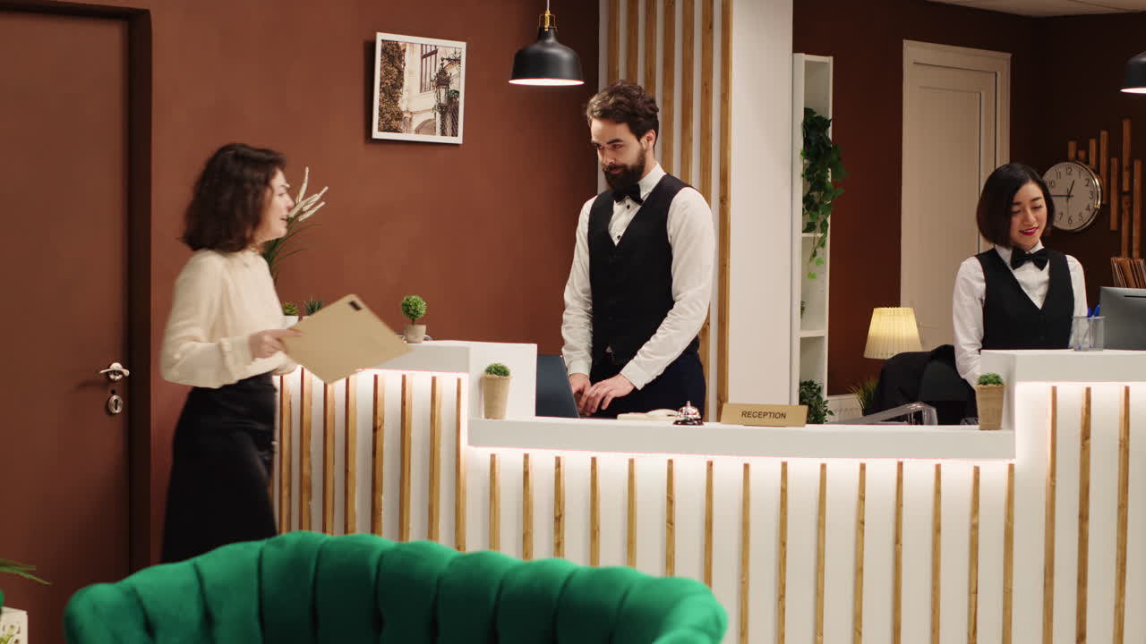 Hotel administrator handing booking file