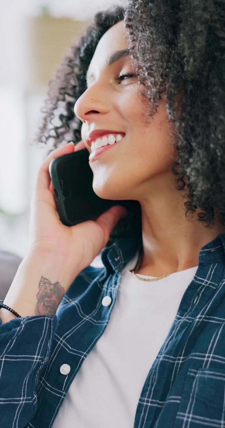 Smiling Woman Talking on Smartphone at Home