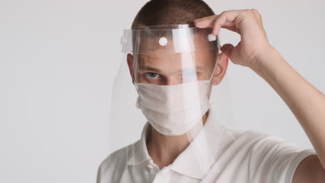 young man putting second protective mask on